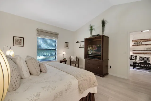 a bedroom with a bed and a television