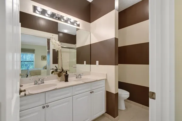 a bathroom with a double vanity sink and mirror