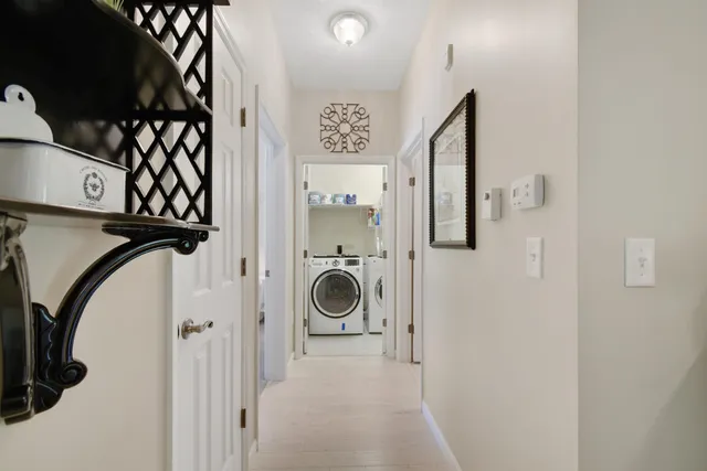 a view of a hallway with washer and dryer