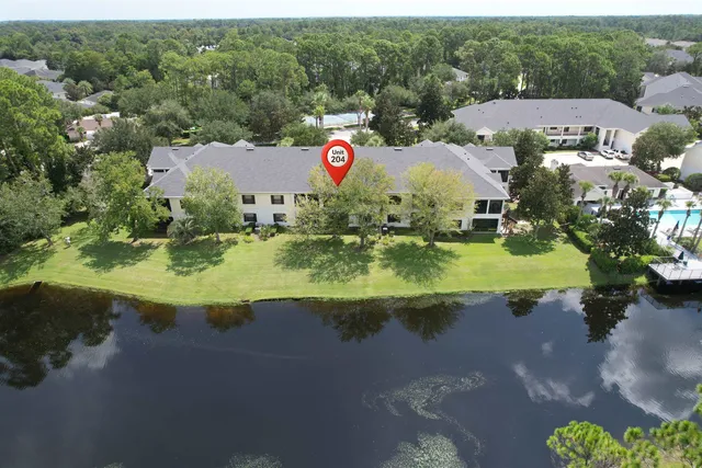 an aerial view of a house with yard and green space