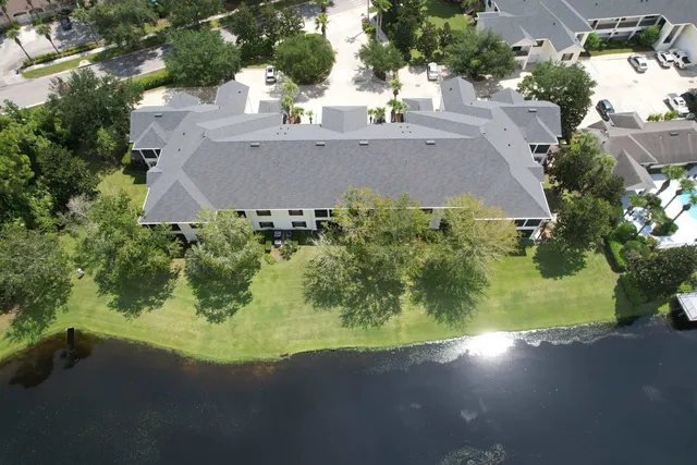 an aerial view of a house with garden space and street view