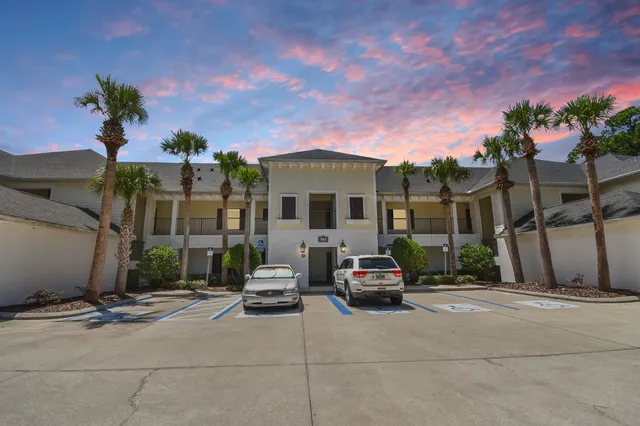 a view of a house with a yard and garden