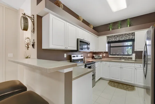 a kitchen with stainless steel appliances granite countertop a sink and cabinets
