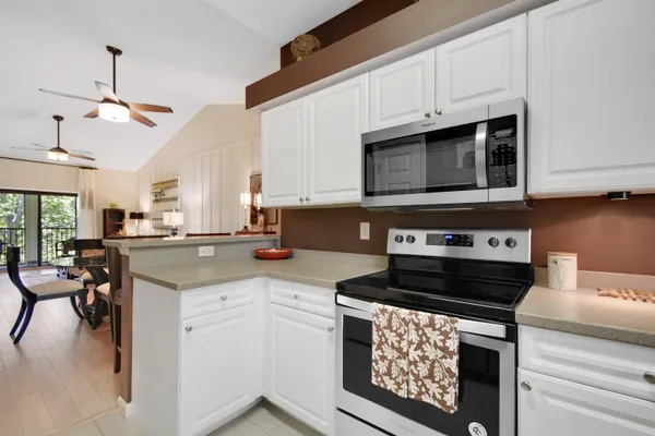 a kitchen with a stove a sink and a microwave