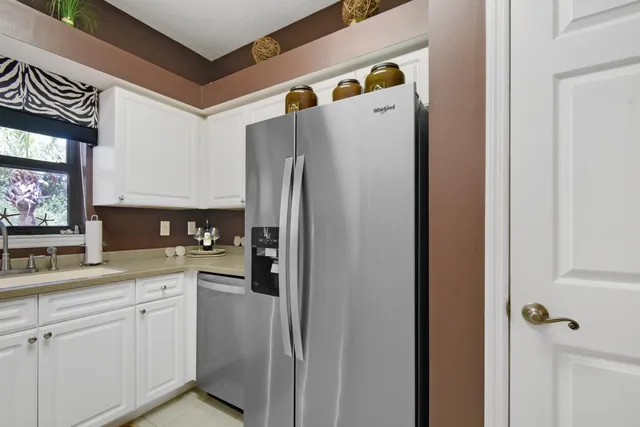 a white refrigerator freezer sitting inside of a kitchen