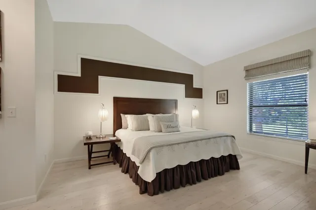 a bedroom with a bed and a night stand