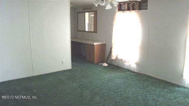 12565 Shark Road Jacksonville, FL 32226 - Photo 3 of 14 an empty room with an entryway