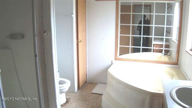 12565 Shark Road Jacksonville, FL 32226 - Photo 4 of 14 a bathroom with a sink and a toilet