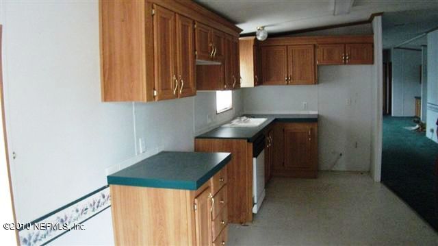 12565 Shark Road Jacksonville, FL 32226 - Photo 8 of 14 a kitchen with a sink a stove and a refrigerator
