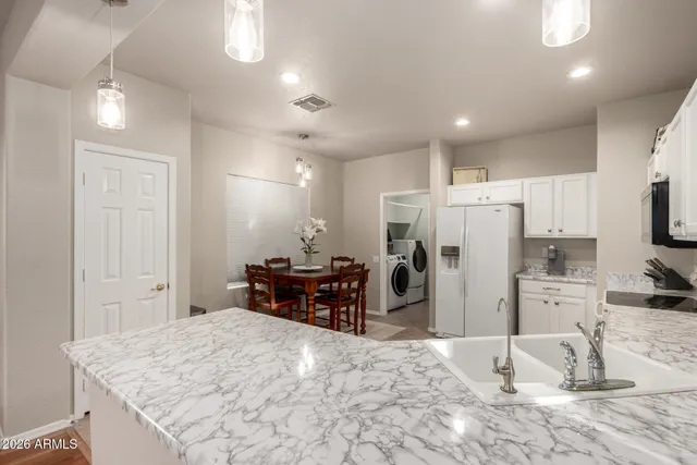 a kitchen with refrigerator and cabinets