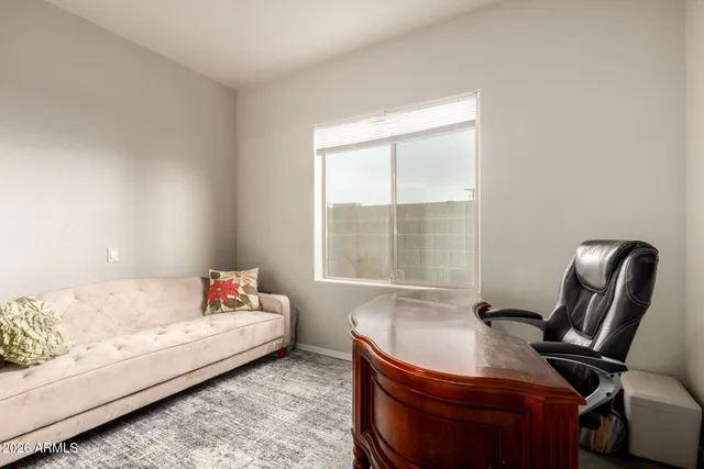 a bedroom with a bed chair and window