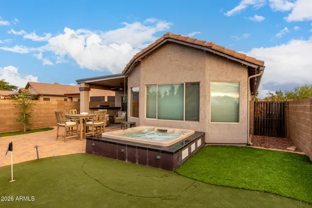 a view of house with backyard and swimming pool