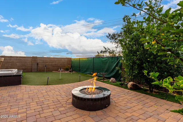 a backyard of a house with a fountain and a garden