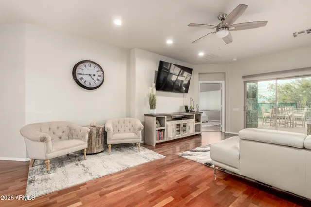a living room with furniture kitchen view and a large window