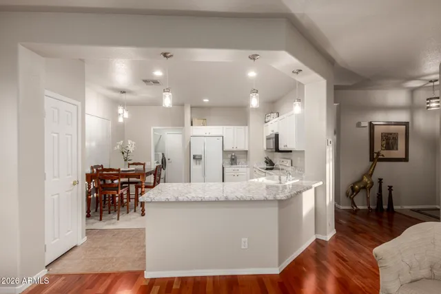 a living room with stainless steel appliances kitchen island granite countertop furniture and a kitchen view