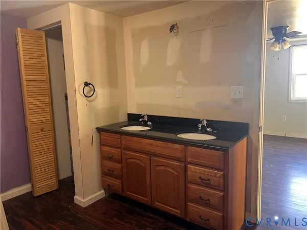 a bathroom with a granite countertop sink and a mirror