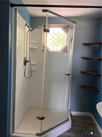 a bathroom with a glass shower door