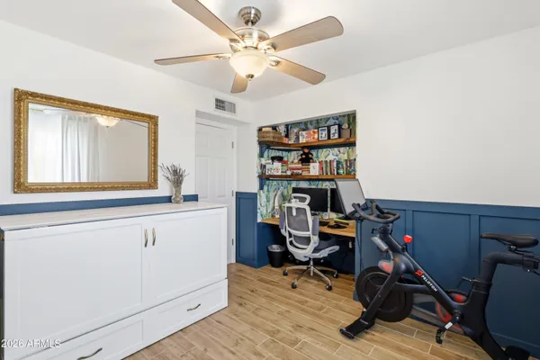 a view of a workspace with furniture and a window