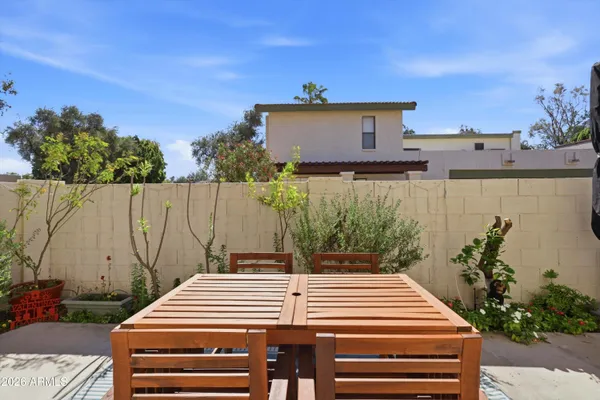 a view of a patio with a table and chairs