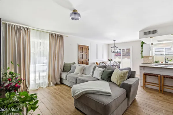 a living room with furniture and a potted plant