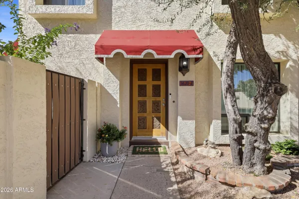 a view of a house with a yard and sitting area