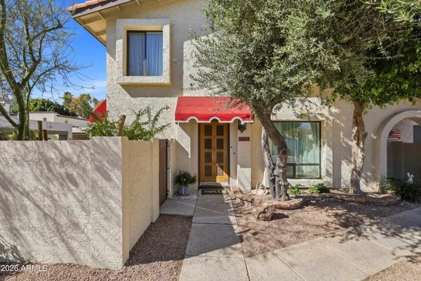 a aerial view of a house with a yard and large trees
