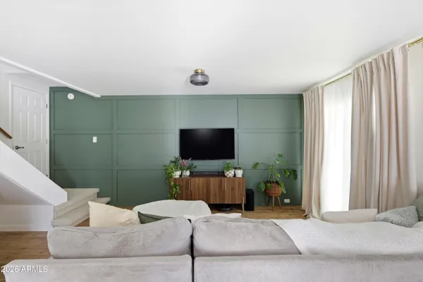 a living room with furniture and a flat screen tv