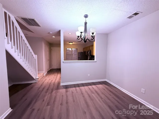 a view of a room with wooden floor
