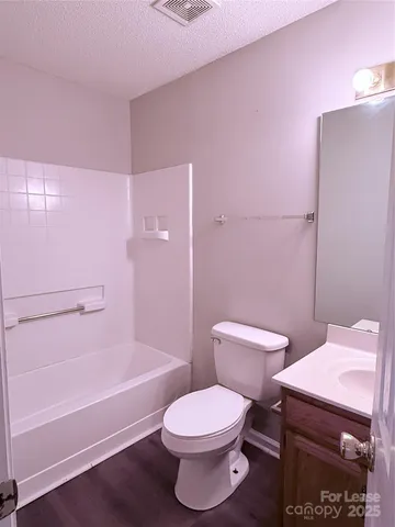 a bathroom with a toilet a sink and bathtub