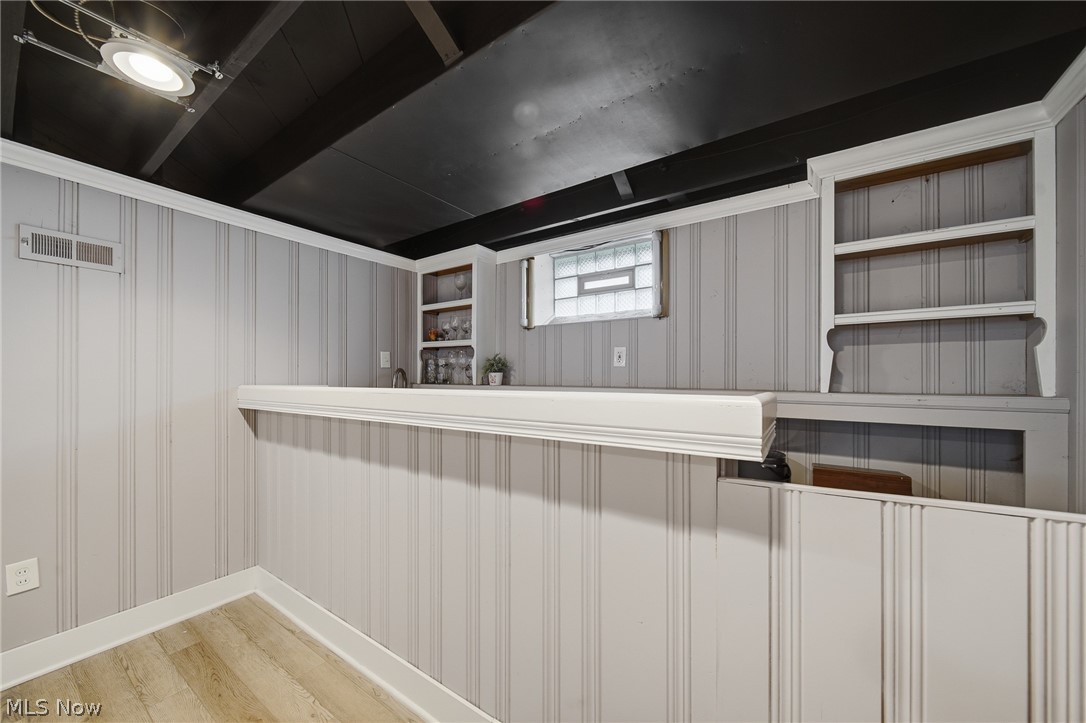 2231 Brockway Road University Heights, OH 44118 - Photo 32 of 46 Finished basement space featuring a built-in wetbar with white cabinetry, open shelving, and a small sink