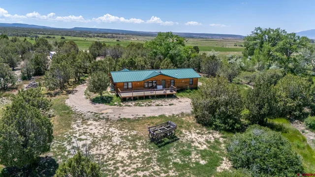 a backyard of a house with a yard and outdoor seating