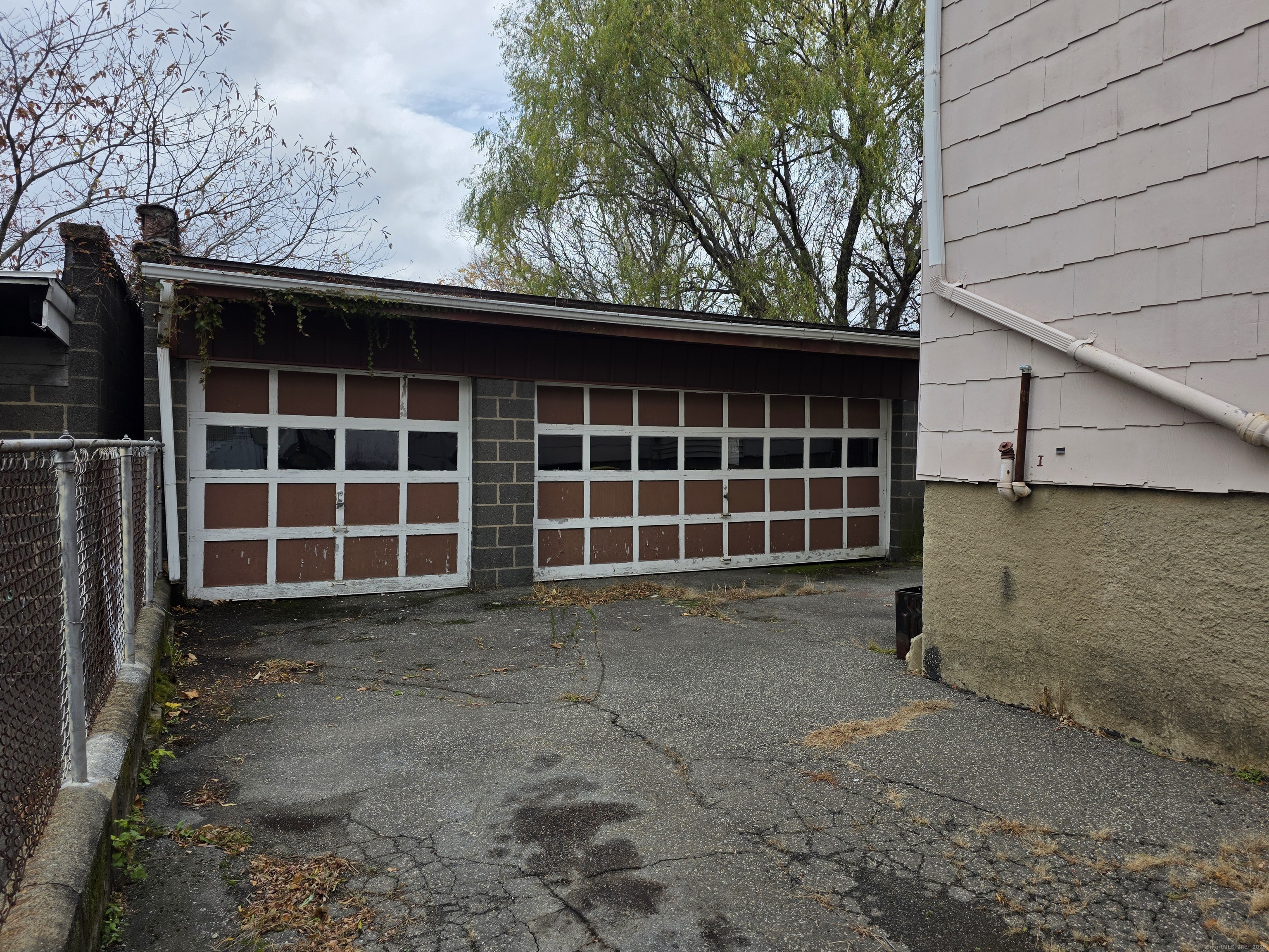 166 Oak Street, Unit 2 Waterbury, CT 06704 - Photo 13 of 13 a view of a house with a large window and wooden fence