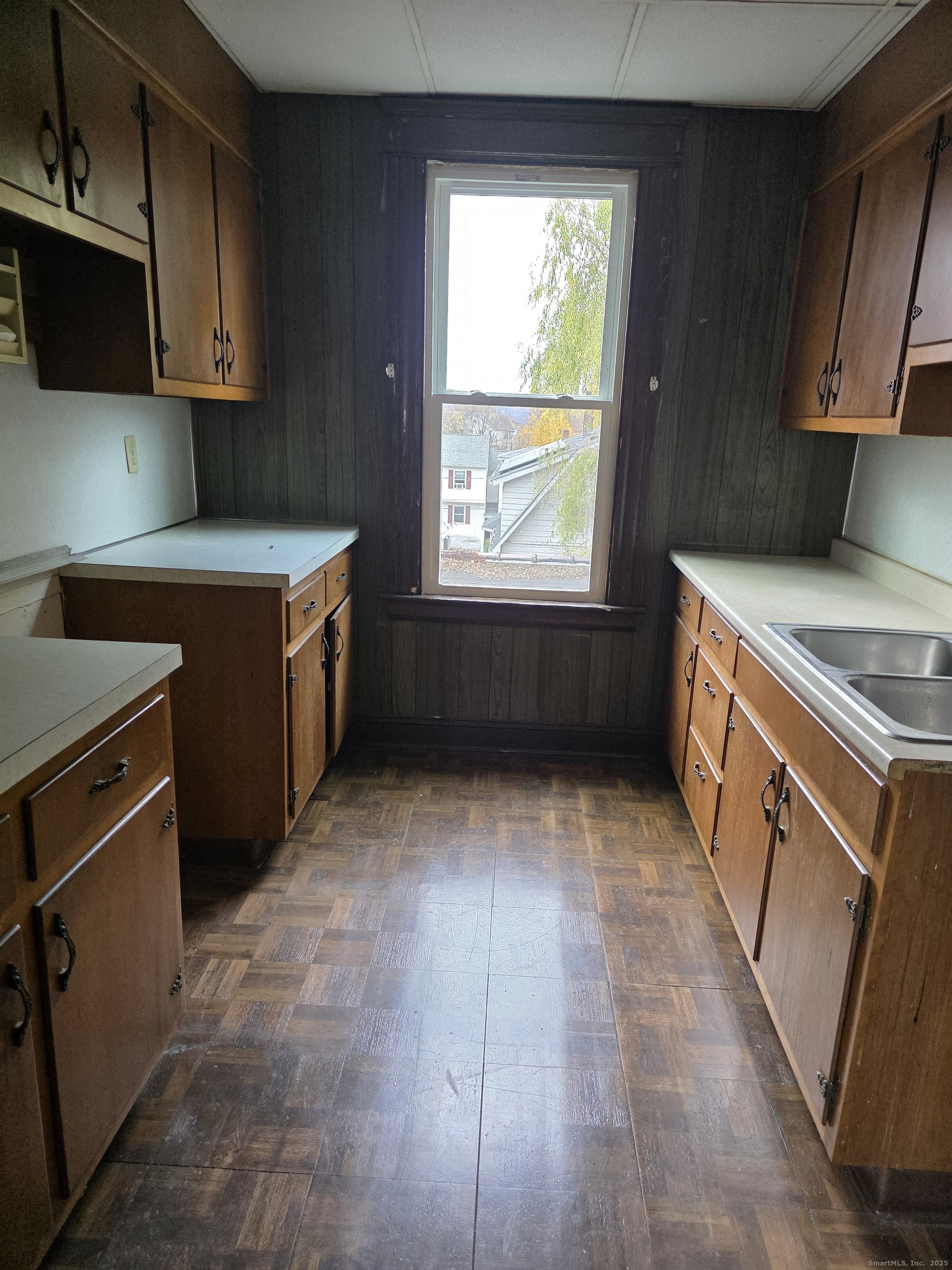 166 Oak Street, Unit 2 Waterbury, CT 06704 - Photo 4 of 13 a kitchen with a stove a microwave and wooden cabinets