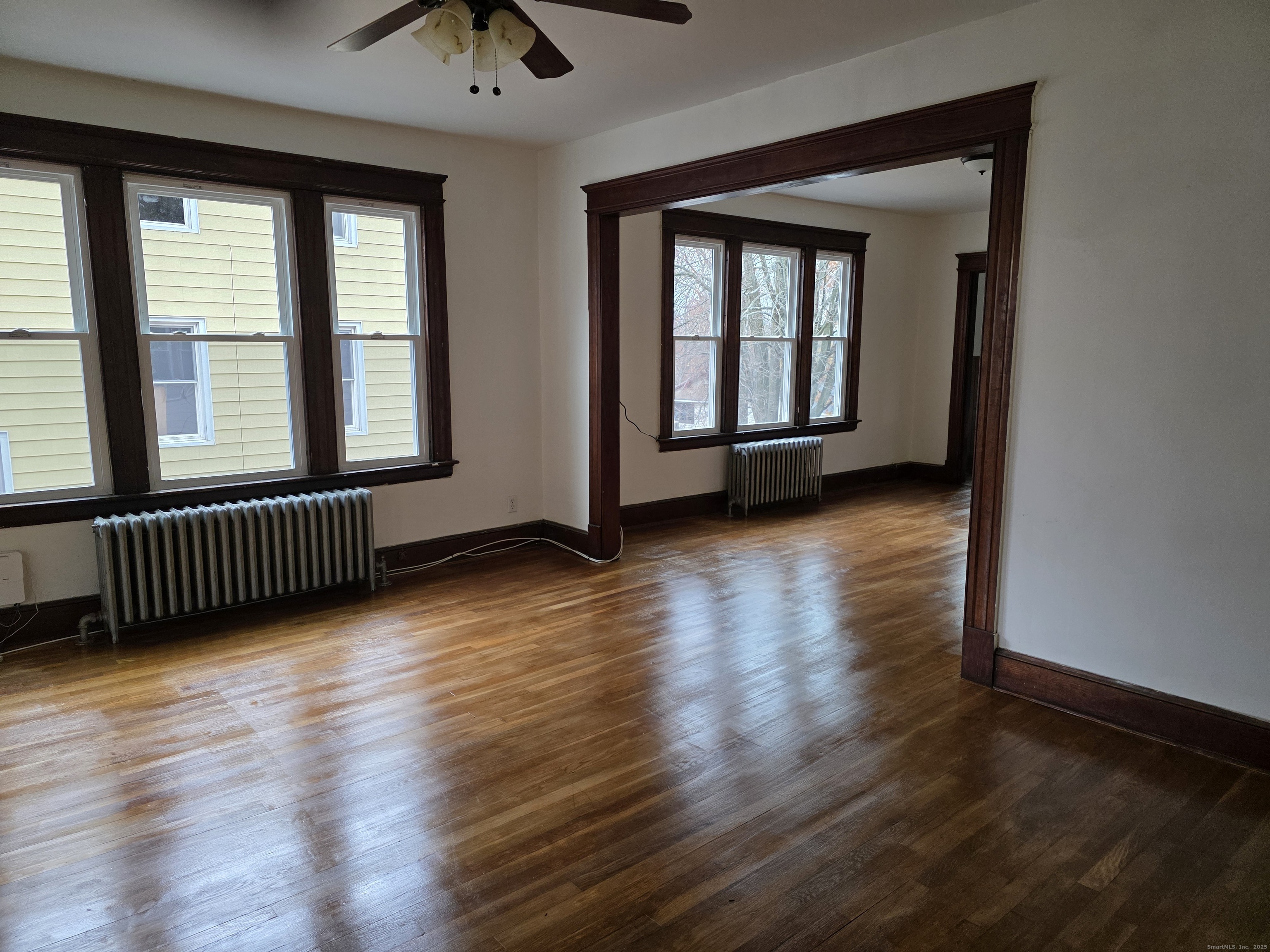 166 Oak Street, Unit 2 Waterbury, CT 06704 - Photo 9 of 13 a view of an empty room with wooden floor and a window