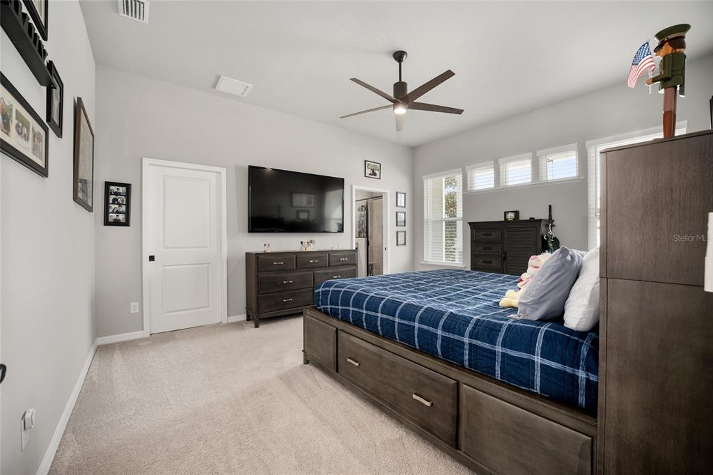 12092 Southwest 29th Place Gainesville, FL 32608 - Photo 13 of 38 a living room with a bed furniture and a flat screen tv