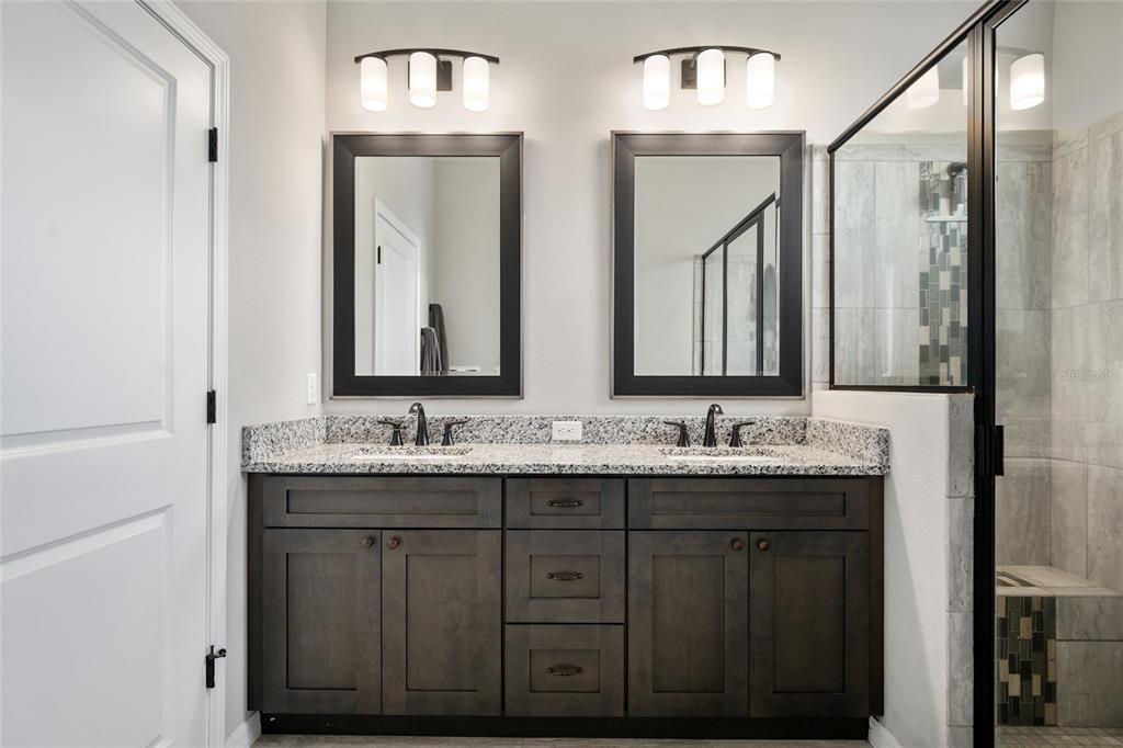 12092 Southwest 29th Place Gainesville, FL 32608 - Photo 16 of 38 a bathroom with double sink and a mirror
