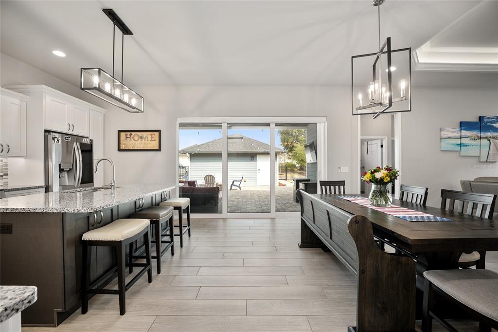 12092 Southwest 29th Place Gainesville, FL 32608 - Photo 5 of 38 a large kitchen with a table and chairs