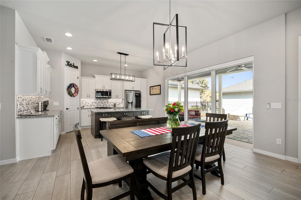 12092 Southwest 29th Place Gainesville, FL 32608 - Photo 6 of 38 a view of a dining room with furniture window and wooden floor