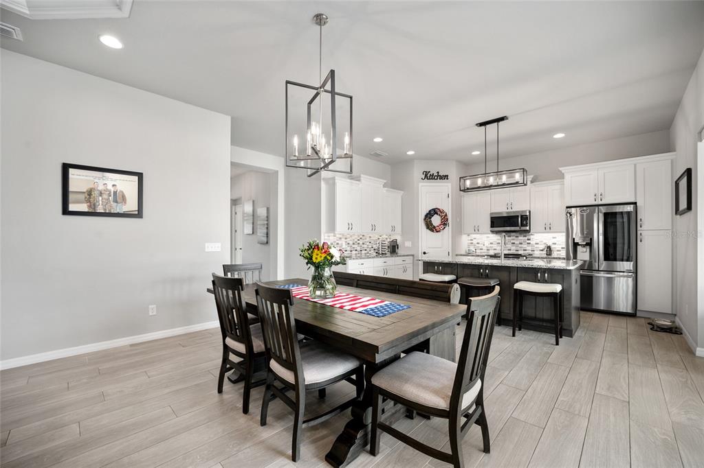 12092 Southwest 29th Place Gainesville, FL 32608 - Photo 7 of 38 a view of a dining room with furniture and wooden floor