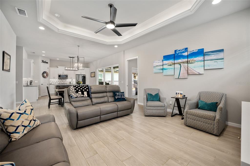 12092 Southwest 29th Place Gainesville, FL 32608 - Photo 8 of 38 a living room with furniture and a ceiling fan