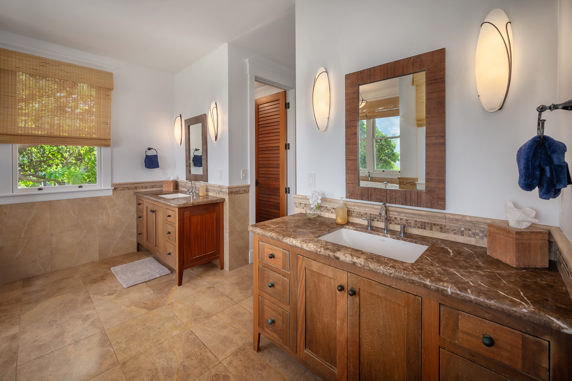 5070 Kukuna Road Kilauea, HI 96754 - Photo 13 of 29 a spacious bathroom with a sink double vanity and a mirror