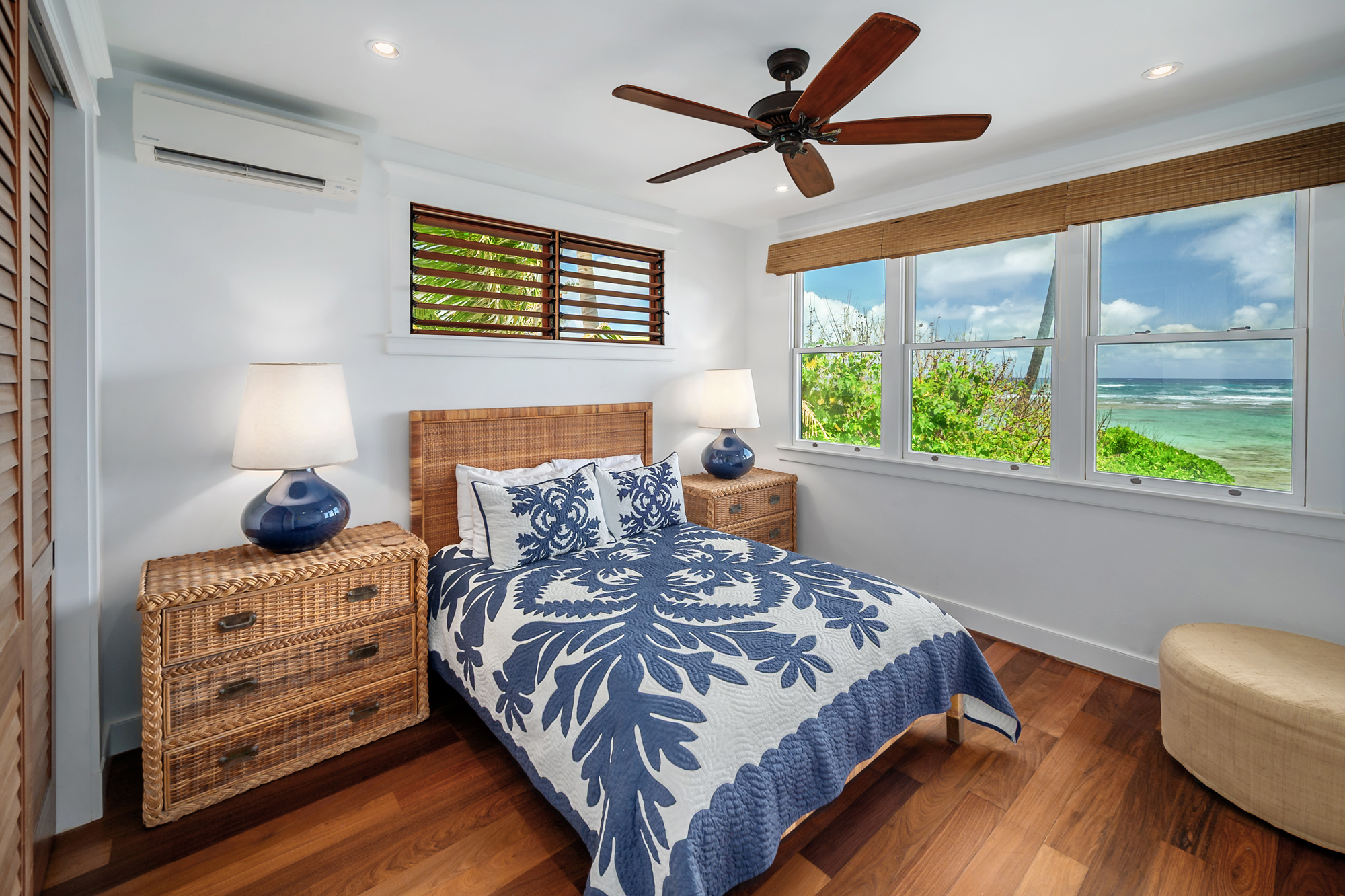 5070 Kukuna Road Kilauea, HI 96754 - Photo 16 of 29 a bedroom with a bed a couch and a window