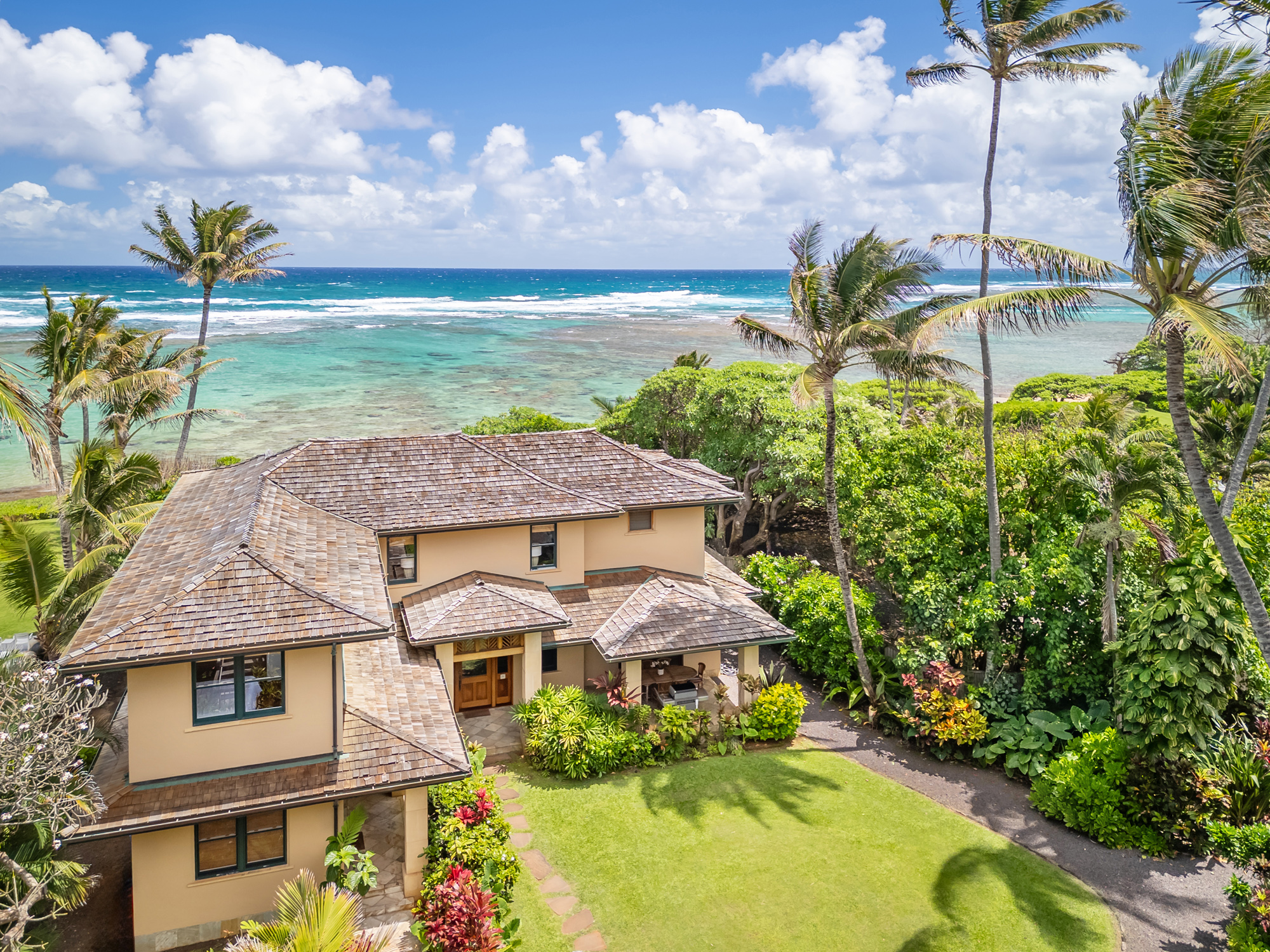 5070 Kukuna Road Kilauea, HI 96754 - Photo 2 of 29 a aerial view of a house with a garden and lake view