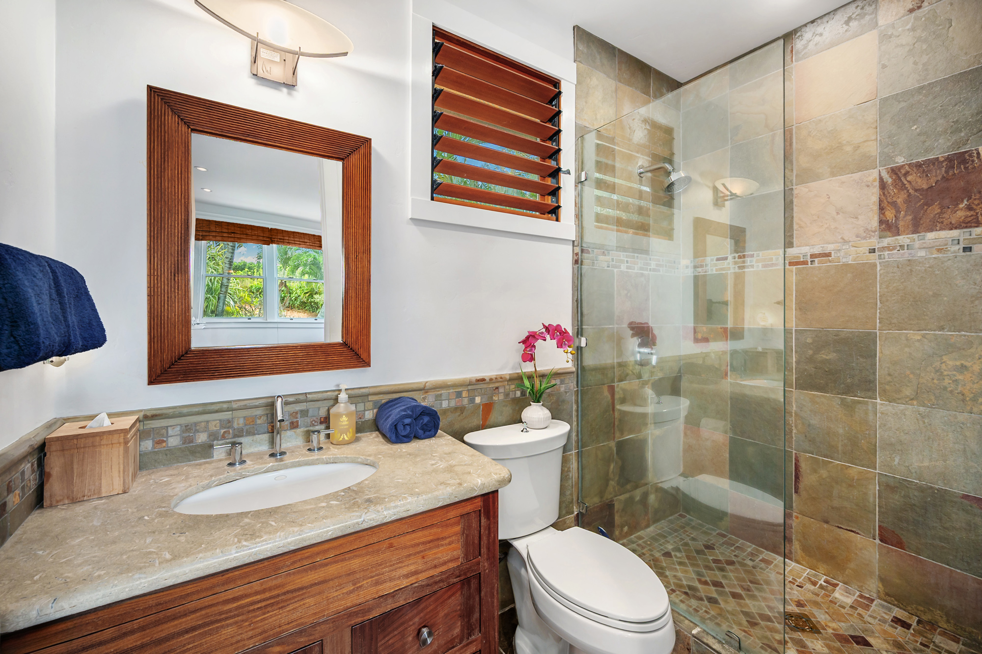 5070 Kukuna Road Kilauea, HI 96754 - Photo 22 of 29 a bathroom with a granite countertop toilet sink and shower