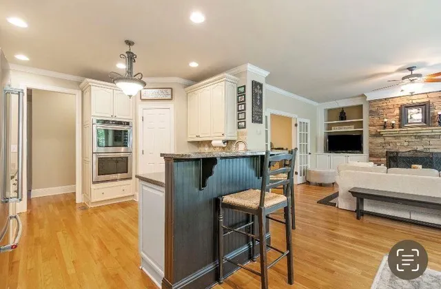 a living room with stainless steel appliances kitchen island granite countertop furniture and a kitchen view