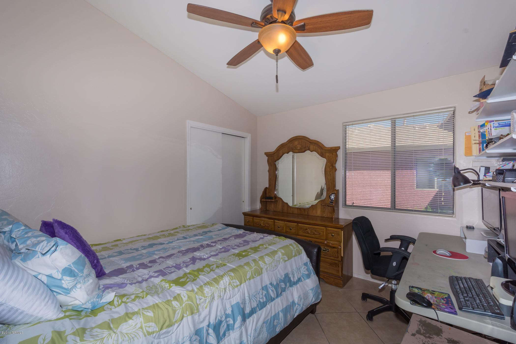 4648 South Valley Road Tucson, AZ 85714 - Photo 25 of 30 a bedroom with a bed and a desk