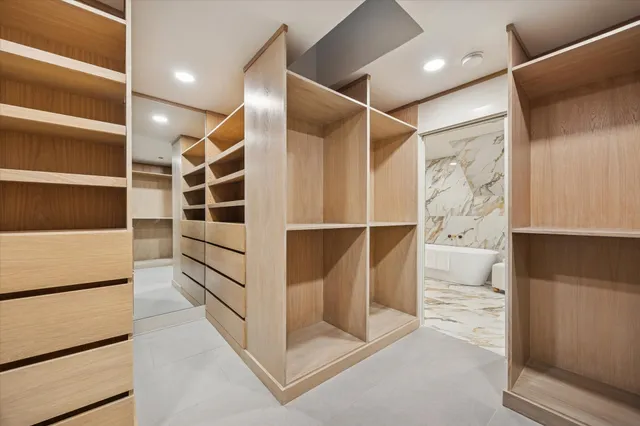 a view of a kitchen with kitchen island a sink wooden floor and a counter top space