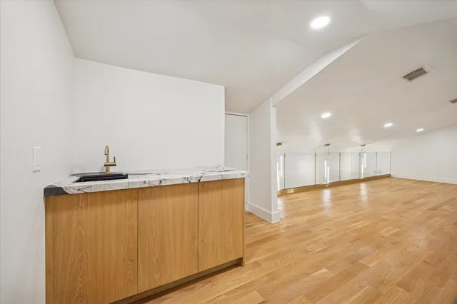 a spacious bedroom with a bed and a couch