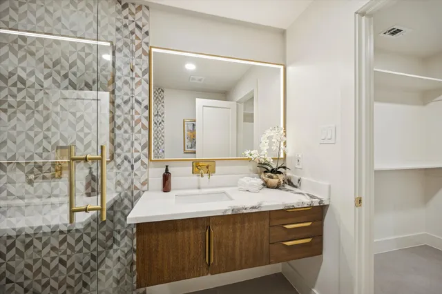 a bathroom with a sink a toilet and mirror