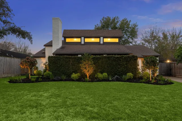 a front view of a house with a garden